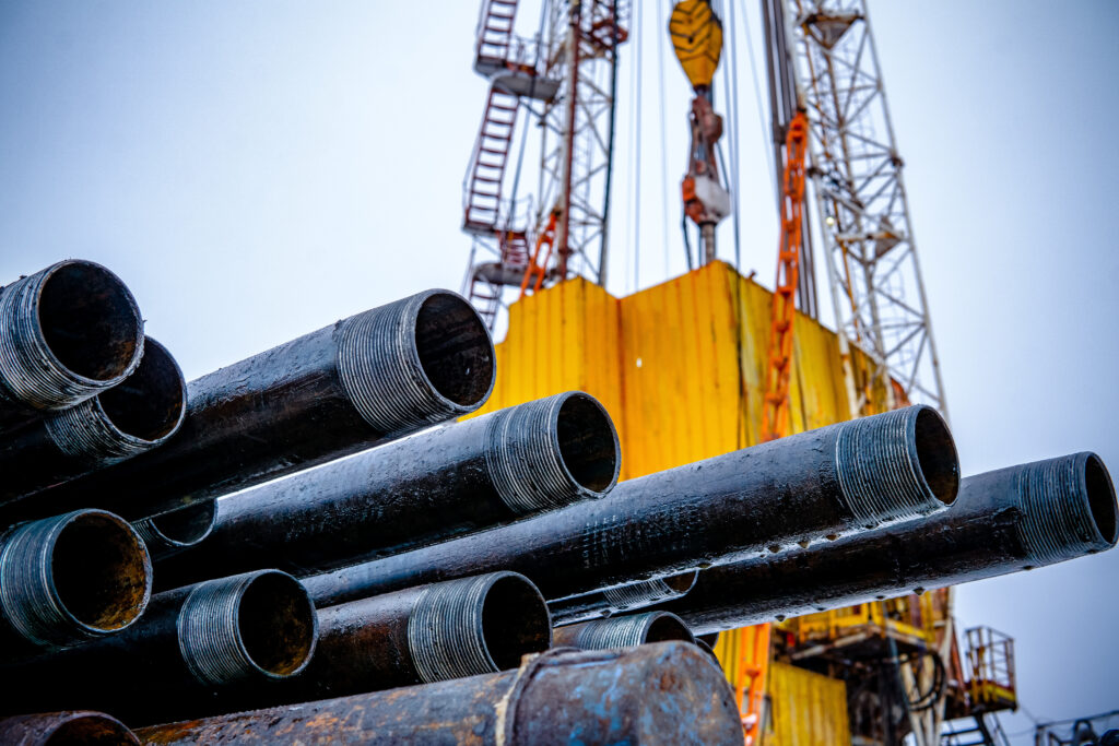 Oil Drill pipe. Rusty drill pipes were drilled in the well section. Downhole drilling rig. Laying the pipe on the deck. View of the shell of drill pipes laid in courtyard of the oil and gas warehouse.