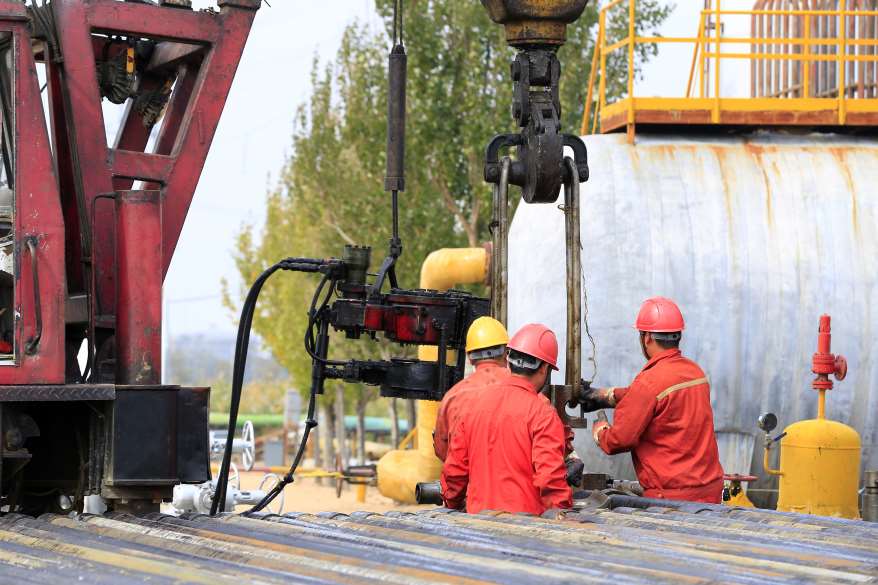 oilfield workers using lifting bails
