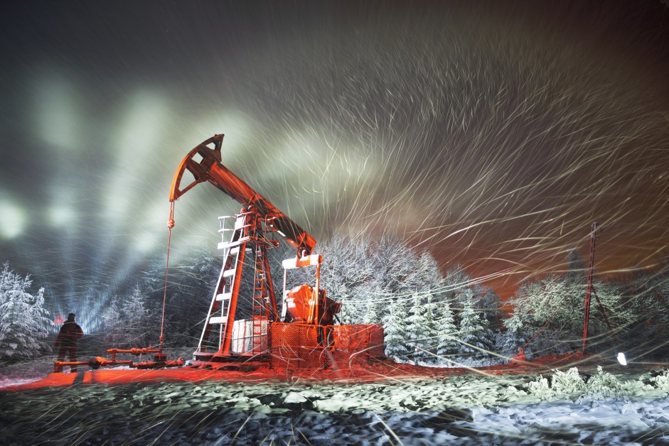 a picture of an oil rig site on a winter night